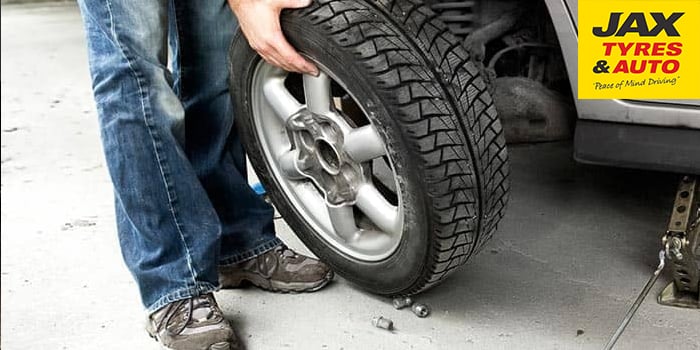 Changing Car Tyres: take the bolts off & remove the tyre