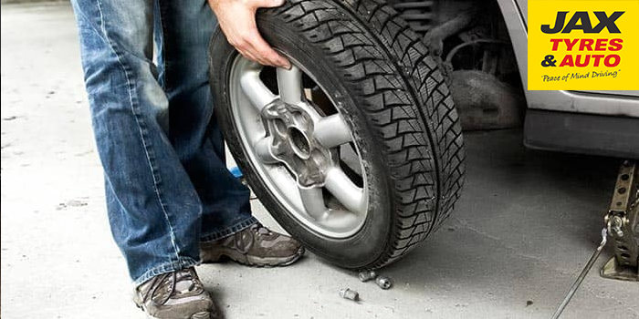 Changing Car Tyres: take the bolts off & remove the tyre